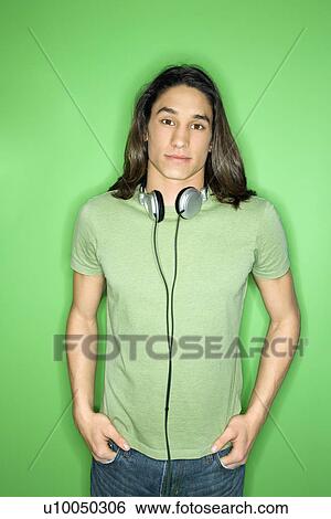 Portrait of Asian-American teen boy with headphones around neck and hands in pockets. View Large Photo Image Stock Photograph - Portrait of Asian-American teen boy with headphones around neck and hands in pockets.. Fotosearch