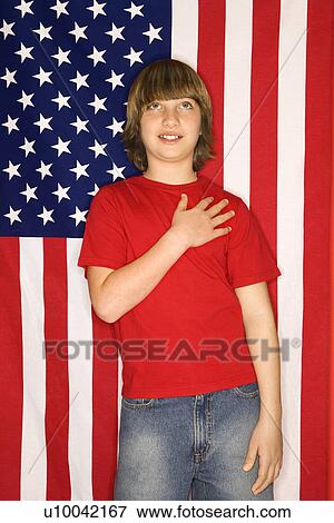 Portrait of Caucasian boy with hand over heart with american flag background. View Large Photo Image Stock Photo - Portrait of Caucasian boy with hand over heart with american flag background.. Fotosearch
