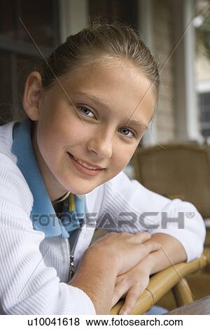 Stock Photo - Portrait of Caucasian pre-teen girl looking at viewer and smiling.. Fotosearch