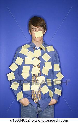 Portrait of Caucasian teen boy standing against blue background covered with blank sticky notes. View Large Photo Image Stock Image - Portrait of Caucasian teen boy standing against blue background covered with blank sticky notes.. Fotosearch