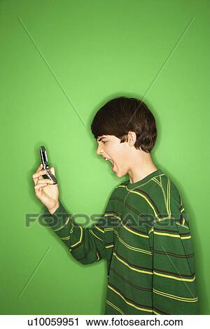 Portrait of Caucasian teen boy screaming at cellphone. View Large Photo Image Stock Image - Portrait of Caucasian teen boy screaming at cellphone.. Fotosearch