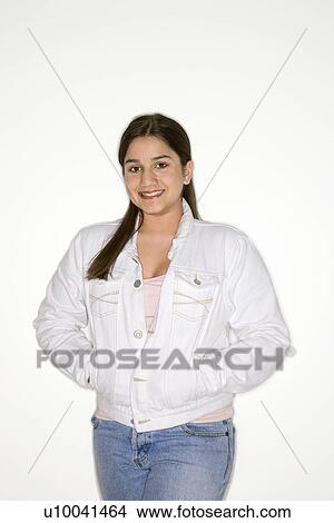 Portrait of smiling Caucasian teen girl with hands in coat pocket against white background. View Large Photo Image Picture - Portrait of smiling Caucasian teen girl with hands in coat pocket against white background.. Fotosearch