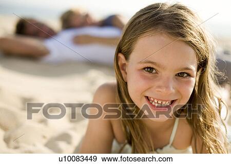 Stock Photo - Daughter and family on beach. Fotosearch