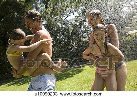 Family at home playing in garden View Large Photo Image Stock Image - Family at home playing in garden. Fotosearch