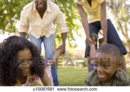 Stock Image - Family in park playing. Fotosearch