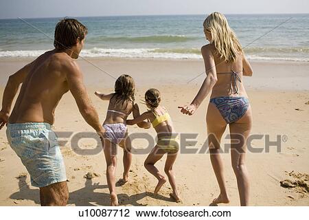 Family on beach playing together View Large Photo Image Stock Image - Family on beach playing together. Fotosearch