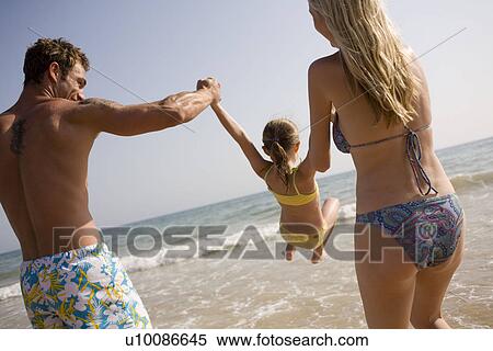 Family on beach playing together View Large Photo Image Stock Photography - Family on beach playing together. Fotosearch