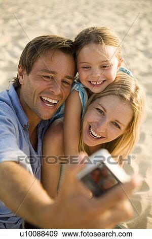 Family on beach, with camera View Large Photo Image Stock Photo - Family on beach, with camera. Fotosearch