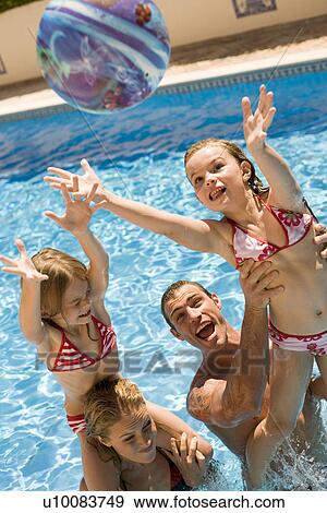 Family playing in pool View Large Photo Image Stock Photo - Family playing in pool. Fotosearch