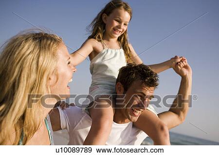 Stock Photo - Family playing on beach. Fotosearch
