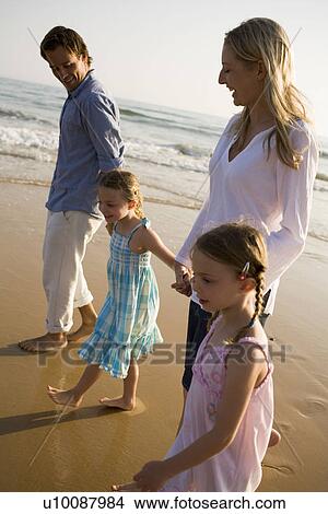Picture - Family walking on beach. Fotosearch