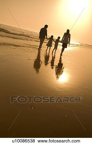 Stock Photo - Family walking on beach. Fotosearch