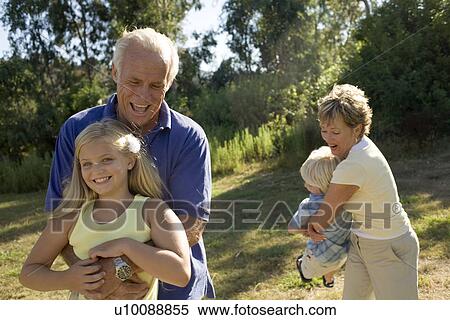 Grandparents and grandchildren in park View Large Photo Image Stock Photography - Grandparents and grandchildren in park. Fotosearch
