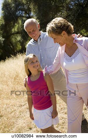 Picture - Grandparents and granddaughter in park. Fotosearch