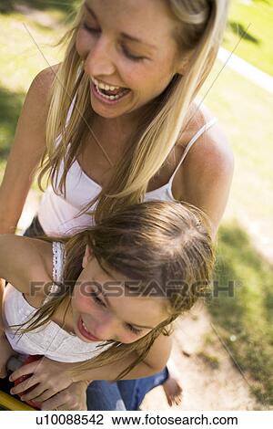 Stock Image - Mother and daughter in park. Fotosearch