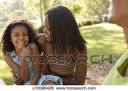 Stock Photograph - Mother and daughter in park. Fotosearch