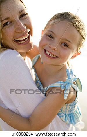 Mother and daughter on beach View Large Photo Image Picture - Mother and daughter on beach. Fotosearch