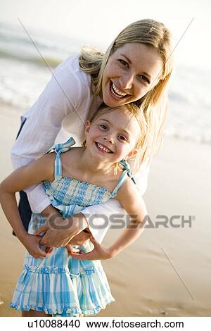 Mother and daughter on beach View Large Photo Image Stock Image - Mother and daughter on beach. Fotosearch