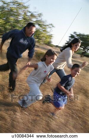 Family in park running in field View Large Photo Image Picture - Family in park running in field. Fotosearch