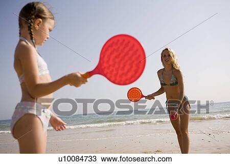 Stock Image - Family on beach playing together. Fotosearch