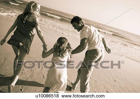 Family on beach playing together View Large Photo Image Stock Photo - Family on beach playing together. Fotosearch
