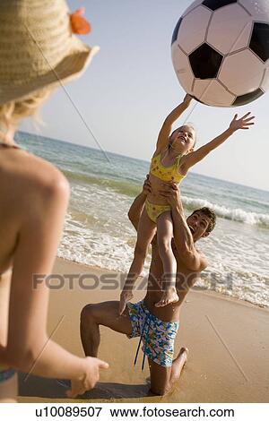 Family on beach playing together View Large Photo Image Stock Photo - Family on beach playing together. Fotosearch