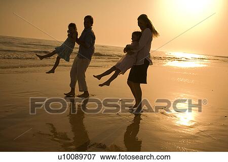 Family playing on beach View Large Photo Image Stock Photo - Family playing on beach. Fotosearch