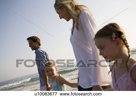 Family walking on beach View Large Photo Image Stock Photo - Family walking on beach. Fotosearch