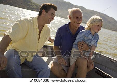 Stock Photograph - Grandfather, son and grandson in boat. Fotosearch