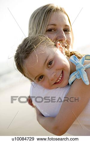 Mother and daughter on beach View Large Photo Image Stock Photo - Mother and daughter on beach. Fotosearch