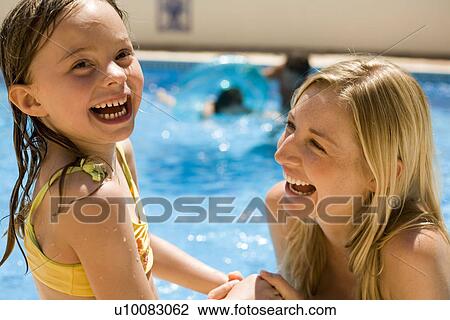 Mother and daughter playing in pool View Large Photo Image Stock Image - Mother and daughter playing in pool. Fotosearch