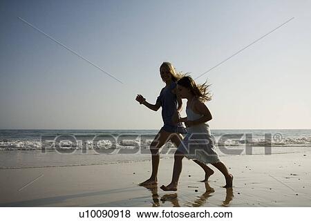 Mother and daughter playing together on beach View Large Photo Image Stock Photo - Mother and daughter playing together on beach. Fotosearch