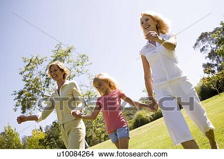 Mother daughter and granddaughter in park View Large Photo Image Picture - Mother daughter and granddaughter in park. Fotosearch
