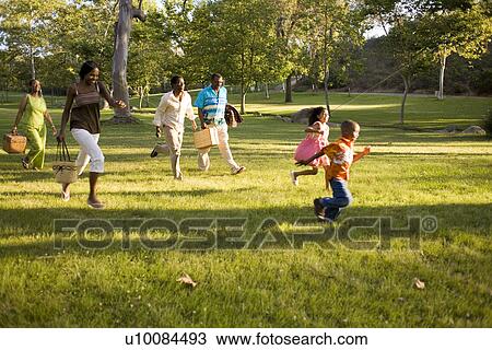 Three Generations of family running in park View Large Photo Image Stock Image - Three Generations of family running in park. Fotosearch
