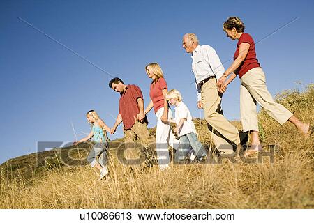 Three generations of family walking in park View Large Photo Image Stock Image - Three generations of family walking in park. Fotosearch