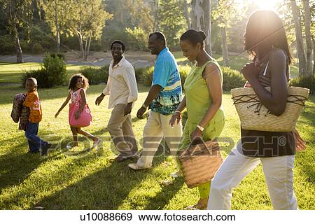 Three Generations of family walking in park View Large Photo Image Stock Photo - Three Generations of family walking in park. Fotosearch