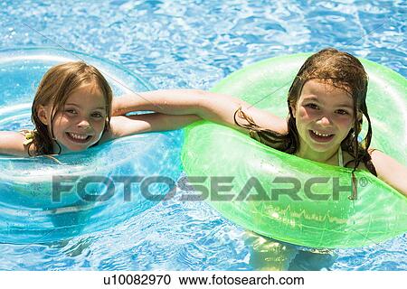 Stock Image - Children playing in pool. Fotosearch