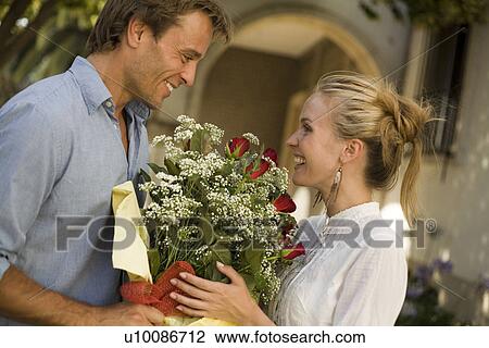 Couple with flowers View Large Photo Image Stock Image - Couple with flowers. Fotosearch