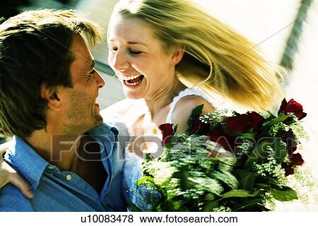Couple with flowers View Large Photo Image Stock Photo - Couple with flowers. Fotosearch