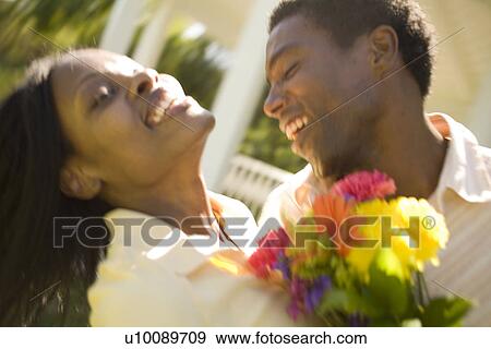 Stock Photo - Couple with flowers. Fotosearch