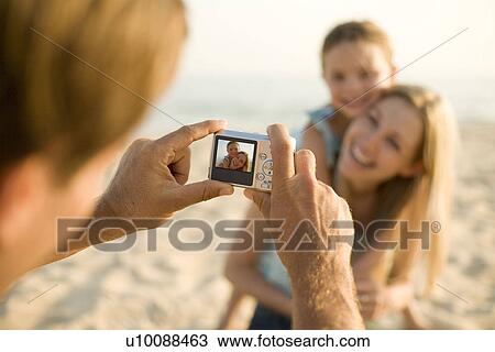 Family on beach, with camera View Large Photo Image Stock Image - Family on beach, with camera. Fotosearch