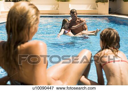 Family playing in pool View Large Photo Image Stock Photo - Family playing in pool. Fotosearch