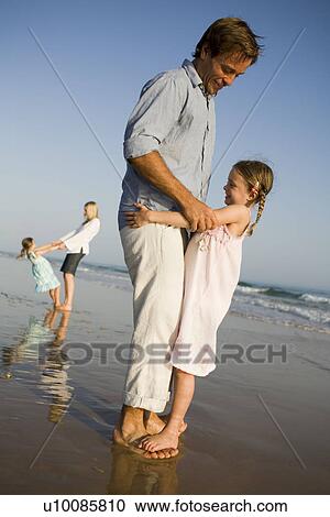 Family playing on beach View Large Photo Image Stock Image - Family playing on beach. Fotosearch