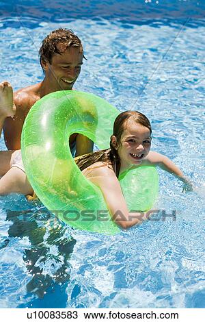 Father and daughter playing in pool View Large Photo Image Stock Image - Father and daughter playing in pool. Fotosearch