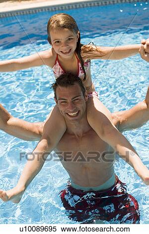Father and daughter playing in pool View Large Photo Image Stock Photography - Father and daughter playing in pool. Fotosearch