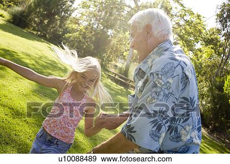 Stock Photo - Grandfather and Granddaughter in park. Fotosearch
