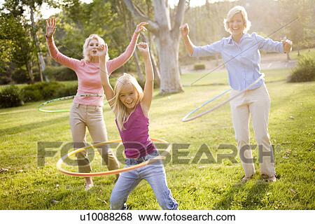 Grandmother, mother and daughter in park with hula hoops View Large Photo Image Stock Photo - Grandmother, mother and daughter in park with hula hoops. Fotosearch