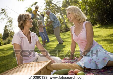 Stock Image - Grandparents and family in park. Fotosearch
