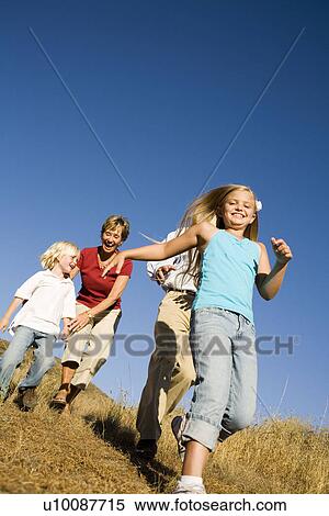 Stock Photography - Grandparents and Grandchildren playing in park. Fotosearch