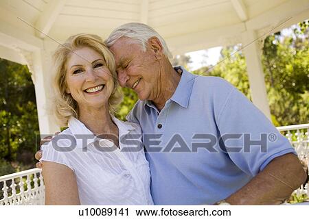 Mature couple in park View Large Photo Image Stock Image - Mature couple in park. Fotosearch